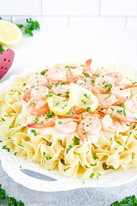 This Shrimp Alfredo Pasta features large shrimp cooked to perfection are covered in a velvety sauce flavored with butter, lemon, and a touch of seasoning.