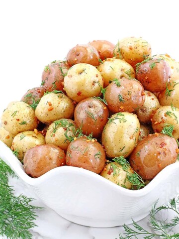 This delicious Roasted Baby Potatoes recipe takes only 30 minutes to make for the most delicious oven-roasted potatoes that are crispy on the outside, and buttery soft on the inside.