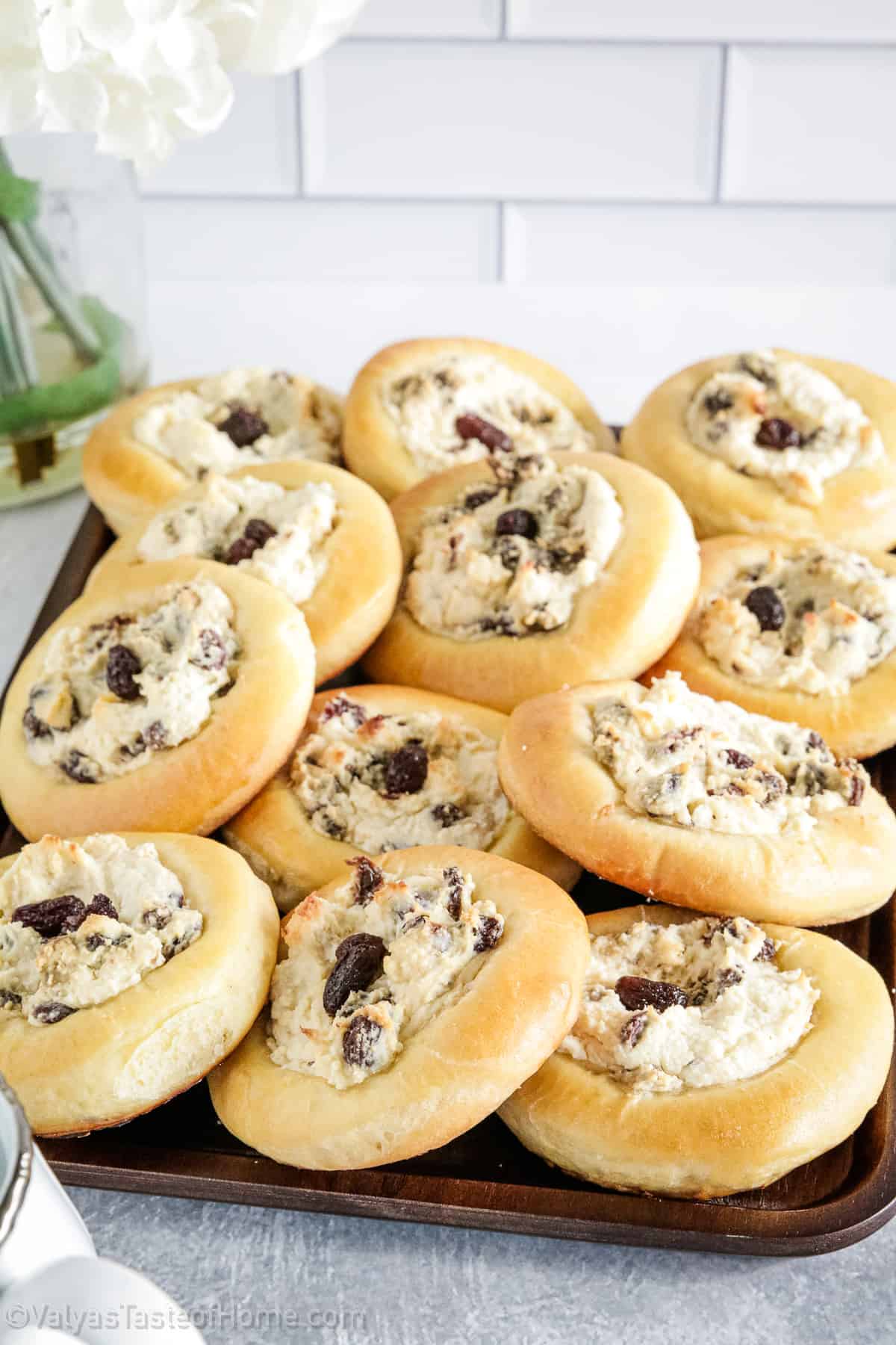 These delicious Sweet Buns feature sweet, light, fluffy buns that are filled with a creamy filling made of farmer's cheese, cream cheese, and the sweetness of raisins. 