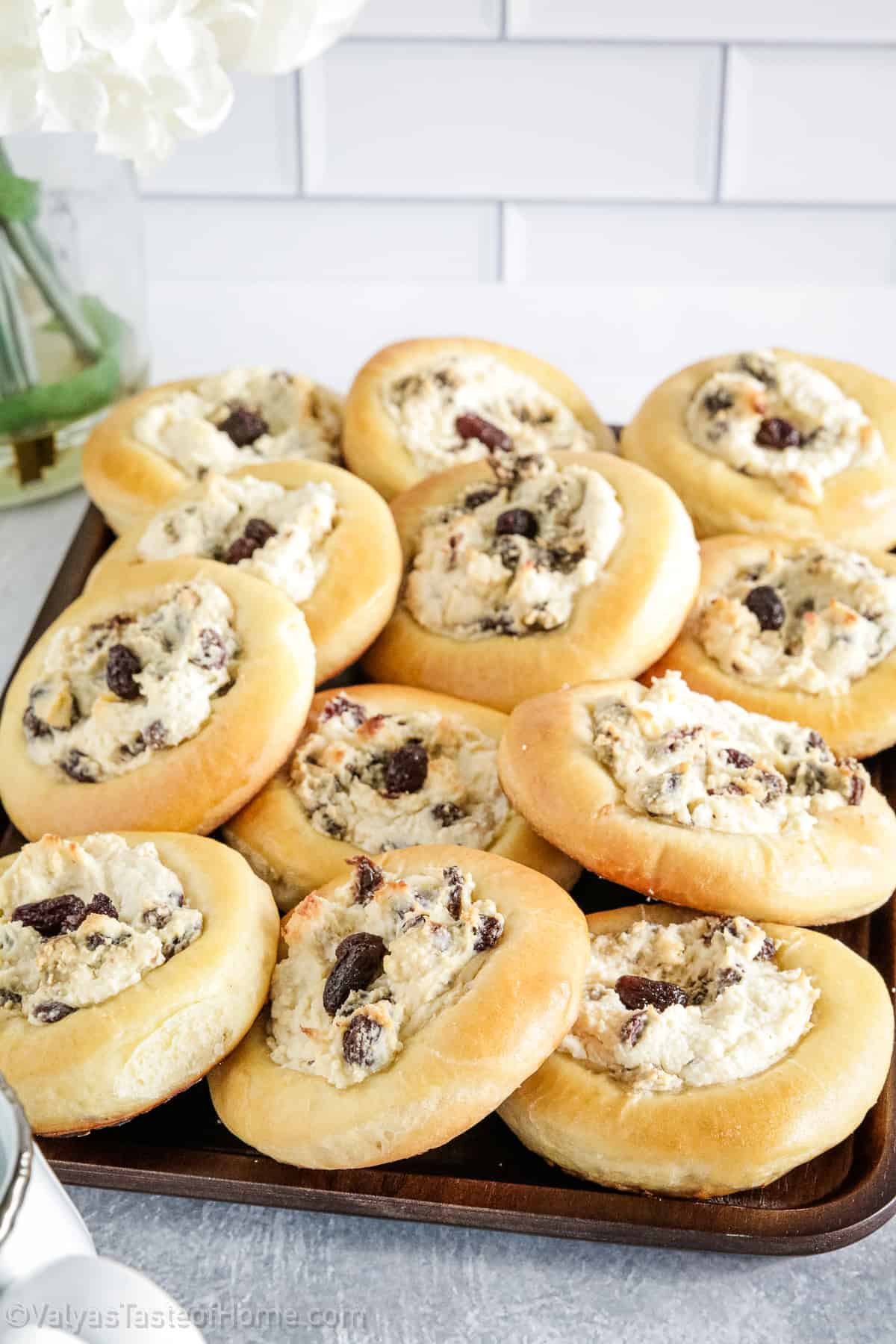 These delicious Sweet Buns feature sweet, light, fluffy buns that are filled with a creamy filling made of farmer's cheese, cream cheese, and the sweetness of raisins.
