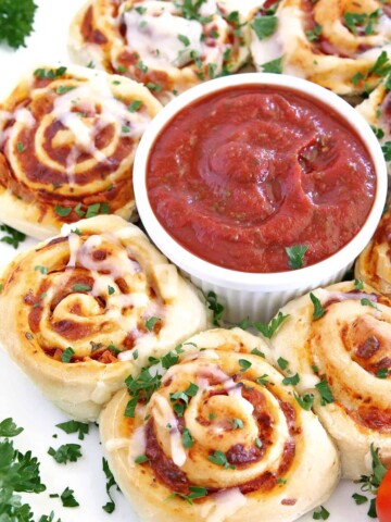 Move over, tiny pizza bites, because here come hearty Easy Pepperoni Pizza Rolls! This recipe is made with my popular super soft and chewy Homemade Pizza Dough, Homemade Pizza Sauce, loads of scrumptious turkey pepperoni, and mozzarella cheese. All rolled up into one amazingly tasty treat that is always a big hit at my house.