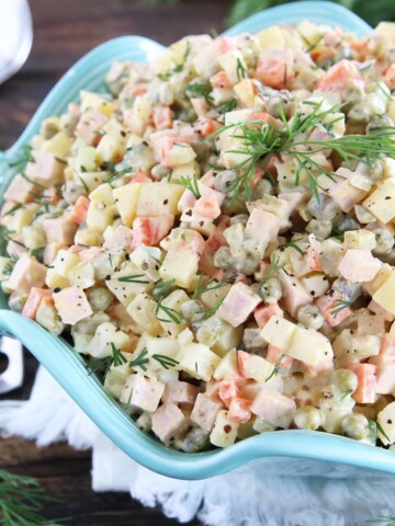 This Classic Potato Salad Recipe (Olivie) is a must-have on any holiday table. It's very easy to make, very hearty, and craveable. Just cook some veggies and eggs, chop them up, add mayo, salt, and pepper and you have a very delicious salad.