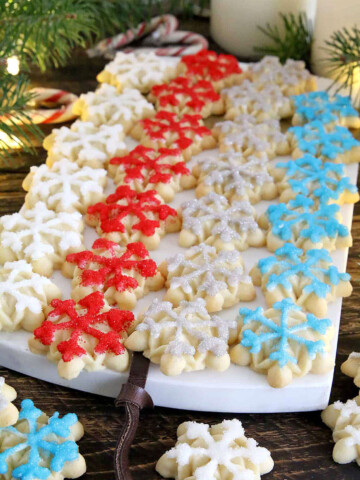 These Snowflake Cookies are crisp, buttery, and delicious cookies that are made using an easy cookie press giving you a stunningly festive result.