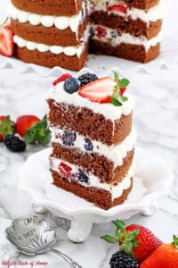 This Berry Cake has a red velvet base and is layered with delicious frosting and berries for a classic look. It's an easy recipe with step-by-step pictures.