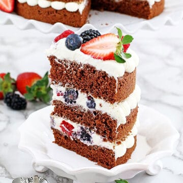 This Berry Cake has a red velvet base and is layered with delicious frosting and berries for a classic look. It's an easy recipe with step-by-step pictures.