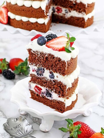 This Berry Cake has a red velvet base and is layered with delicious frosting and berries for a classic look. It's an easy recipe with step-by-step pictures.