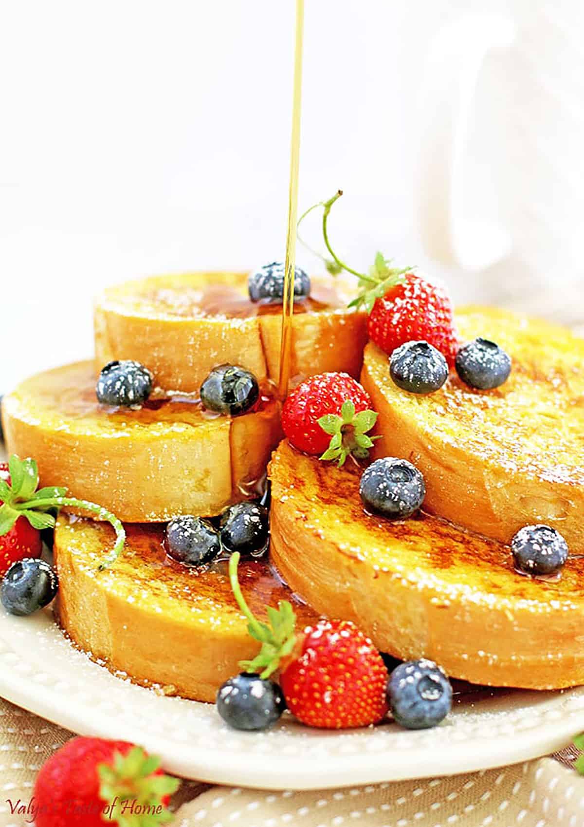 This Mom's French Toast Recipe is made out of homemade French bread slices dipped in a tasty combination of home-raised eggs, sugar, salt, and vanilla mixture, sautéed in butter make them taste so scrumptious, pillow-soft, that melt in your mouth in sweet delight.