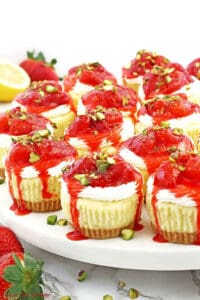 These Mini Strawberry Cheesecakes are made of a buttery graham cracker crust, the tastiest creamy cheesecake filling, and delicious chunky strawberry sauce.