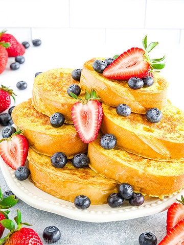 This is the easiest French toast at home recipe made using homemade French bread slices that are dipped in the perfect batter and sauteed in butter for a deliciously soft, sweet, and tasty breakfast!