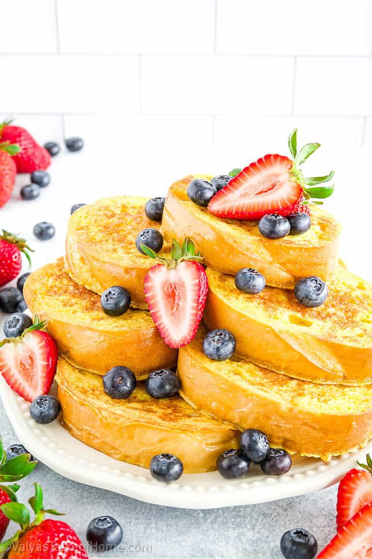 This is the easiest French toast at home recipe made using homemade French bread slices that are dipped in the perfect batter and sauteed in butter for a deliciously soft, sweet, and tasty breakfast!