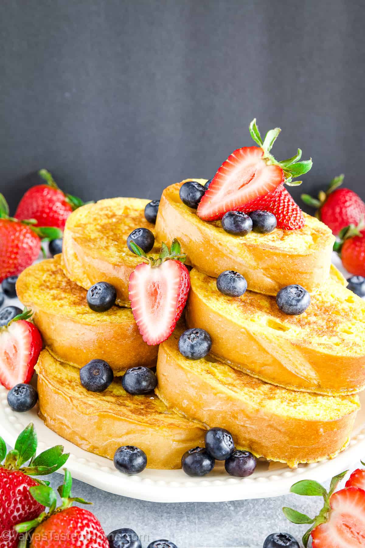This is the easiest French toast at home recipe made using homemade French bread slices that are dipped in the perfect batter and sauteed in butter for a deliciously soft, sweet, and tasty breakfast!