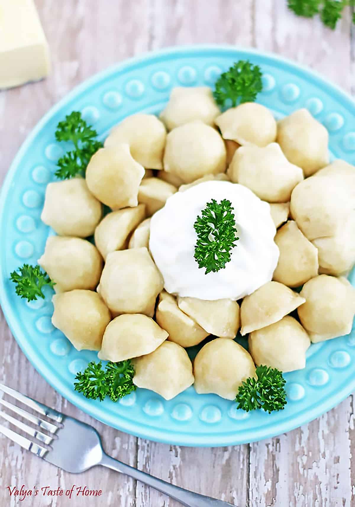 Pelmeni is dumplings that consist of a meat filling wrapped in thin, unleavened dough. Boiled in water, dressed in butter, and served with a gallop of sour cream. They have always been a family favorite and my kids’ frequent requests.