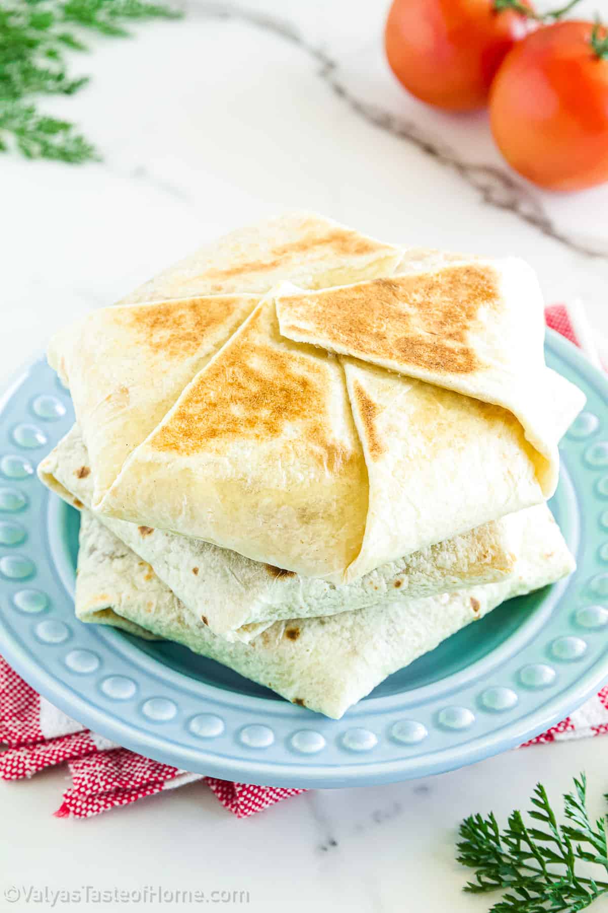 Layers of seasoned beef, nacho cheese, and toppings all in a flour tortilla.