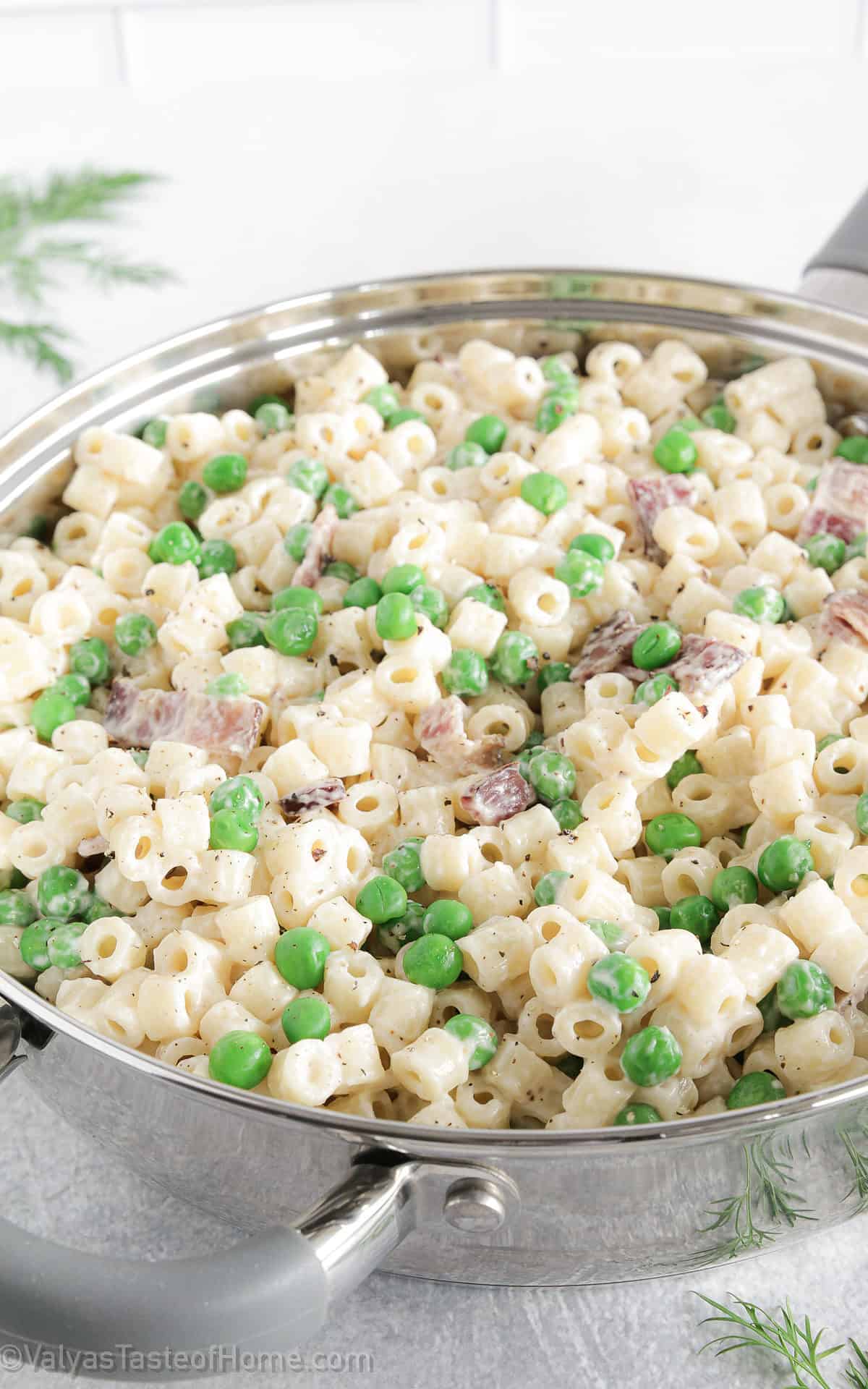This creamy pasta with bacon and peas is the perfect weeknight meal and can be made in under 30 minutes! Plus, kids absolutely love the flavor!