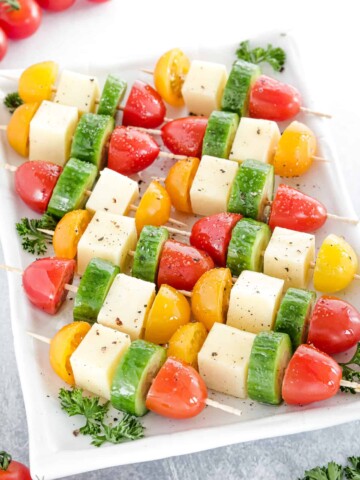 This tasty Mozzarella Appetizers recipe features fresh mozzarella, cherry tomatoes, cucumbers, and the perfect olive oil drizzle for a quick and easy recipe!