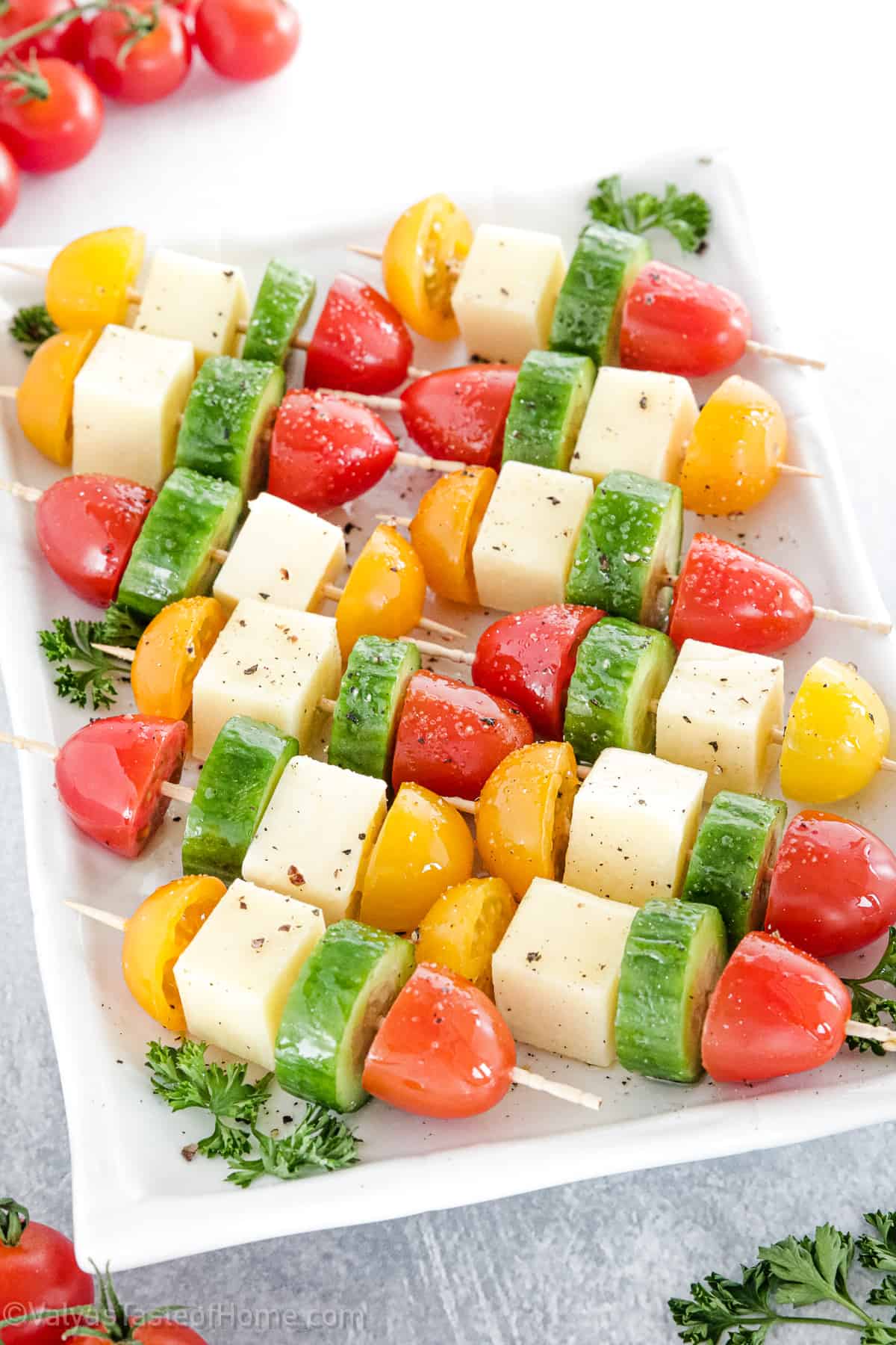 This tasty Mozzarella Appetizers recipe features fresh mozzarella, cherry tomatoes, cucumbers, and the perfect olive oil drizzle for a quick and easy recipe!