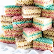 A waffle cake is a type of dessert made by layering colorful wafer cookies with sweetened condensed milk and letting it sit under a press or weight to soften and compress the layers.