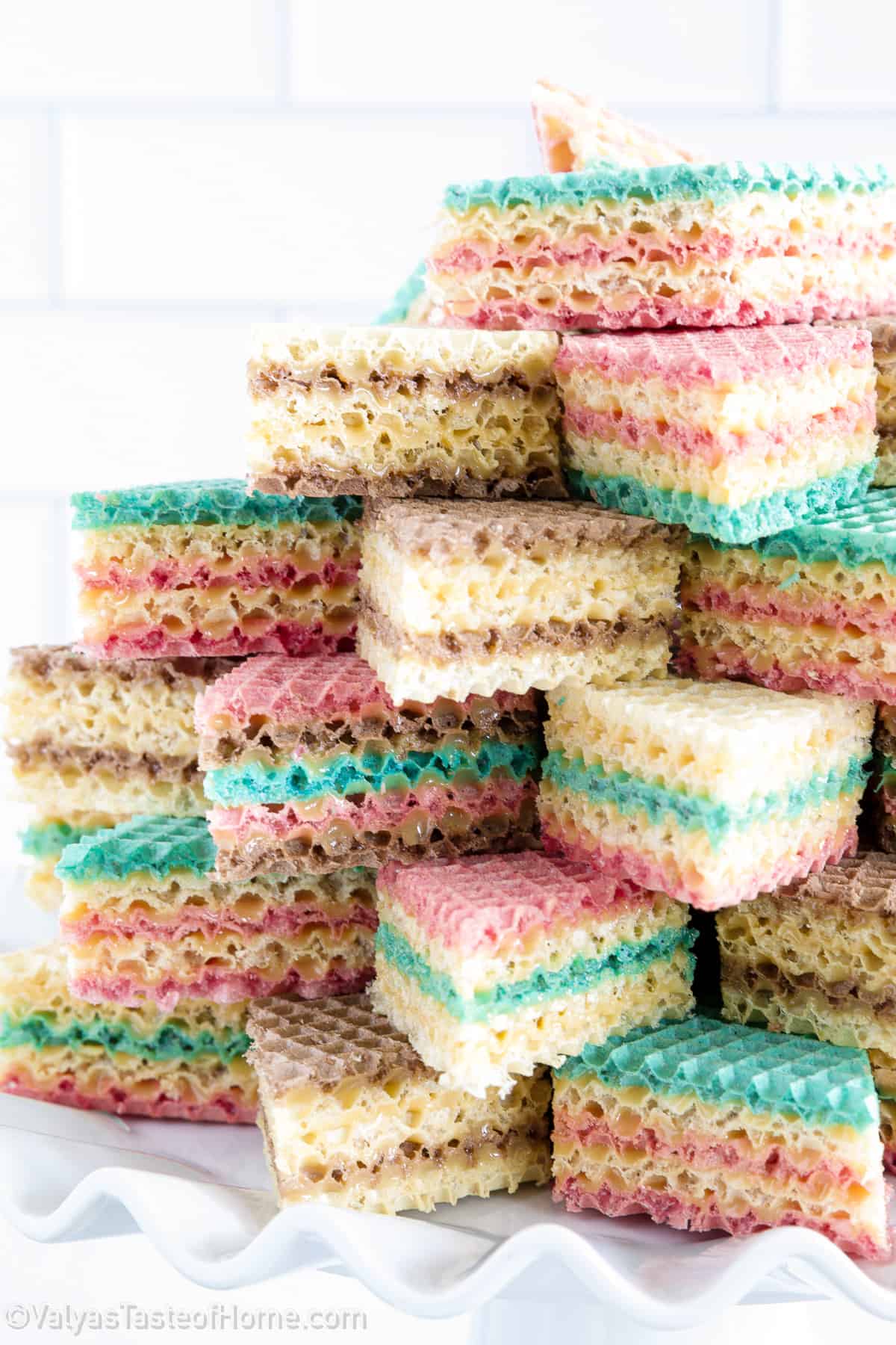 A waffle cake is a type of dessert made by layering colorful wafer cookies with sweetened condensed milk and letting it sit under a press or weight to soften and compress the layers.