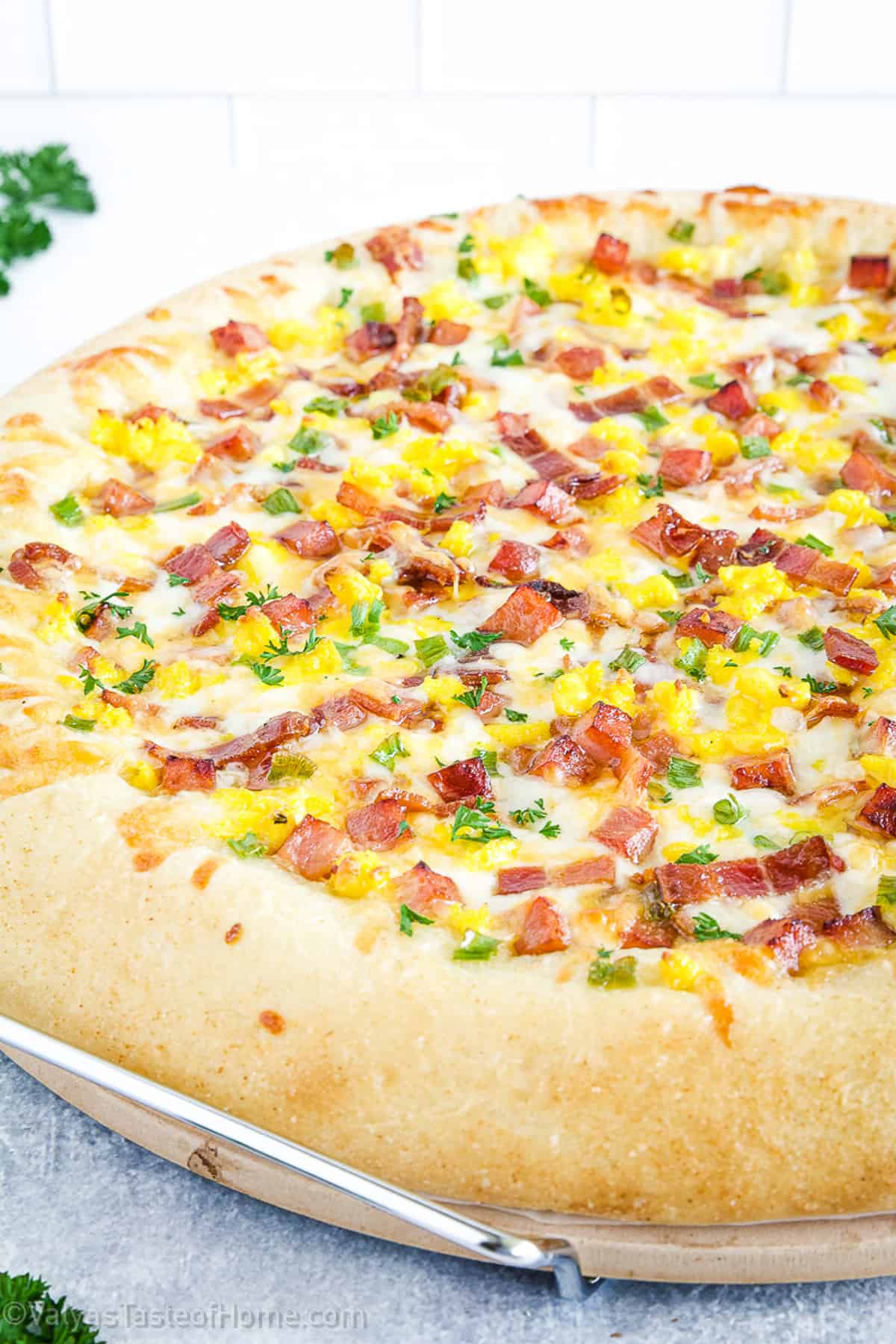 Pizza dish that is typically eaten for breakfast and is topped with breakfast ingredients such as bacon, eggs, cheese, vegetables, and/or sausage.