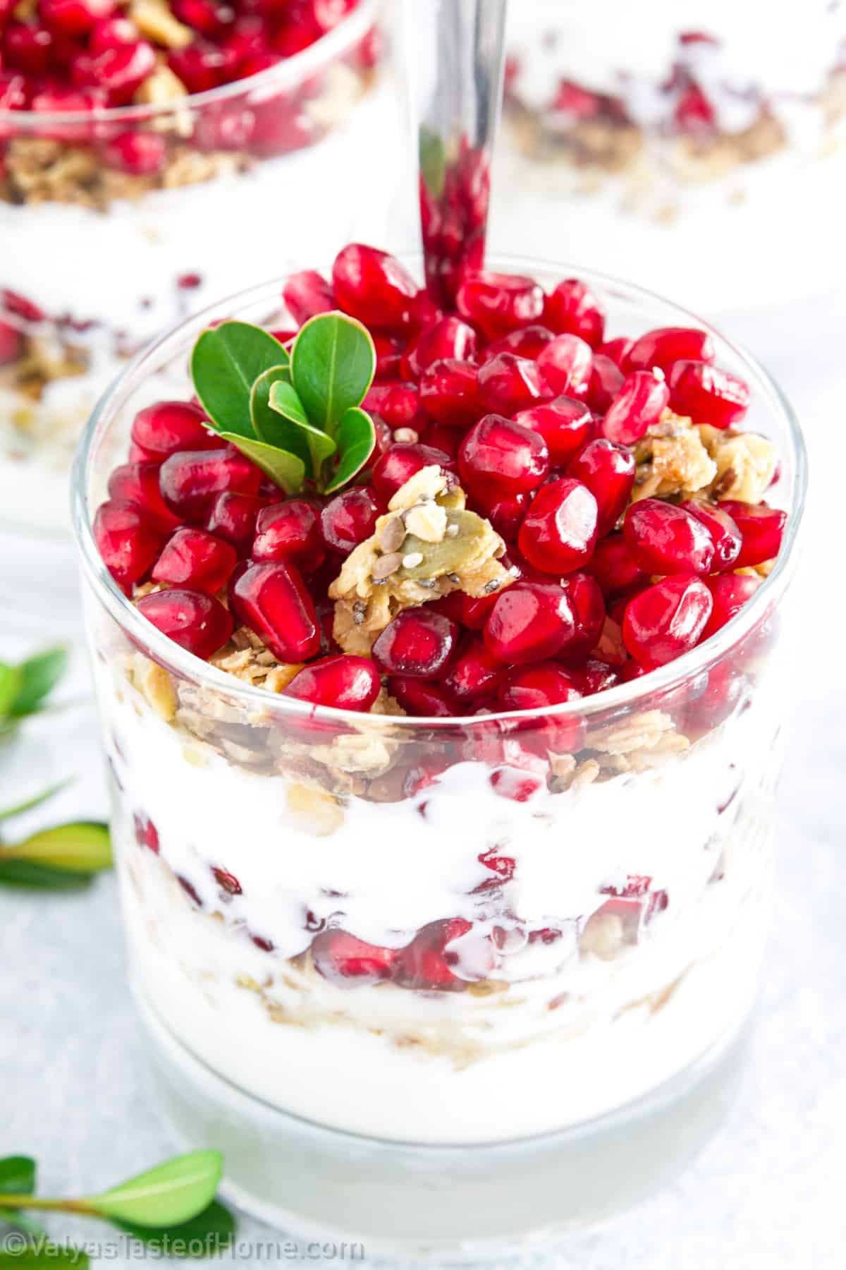 A pomegranate parfait is a delicious layered dessert or breakfast parfait that combines the sweet and tangy flavors of pomegranate seeds with the creamy texture of plain Greek yogurt and the crunchy goodness of granola. 