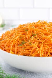 Korean carrot salad, also known as Morkovcha, is a vibrant and flavorful dish that originates from the Koryo-saram people, who are ethnic Koreans residing in Russia.