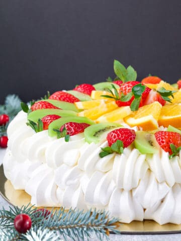 With its delicate meringue base that is crisp on the outside and marshmallow-like on the inside, topped with a luscious layer of whipped cream and an assortment of fresh fruits, this dessert is a true showstopper. 
