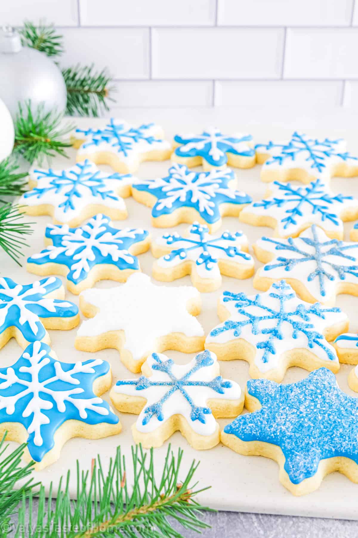 This recipe involves making delicious sugar cookies cut into snowflake shapes using a snowflake cookie cutter, then decorating them with royal icing to mimic the intricate beauty of snowflakes.