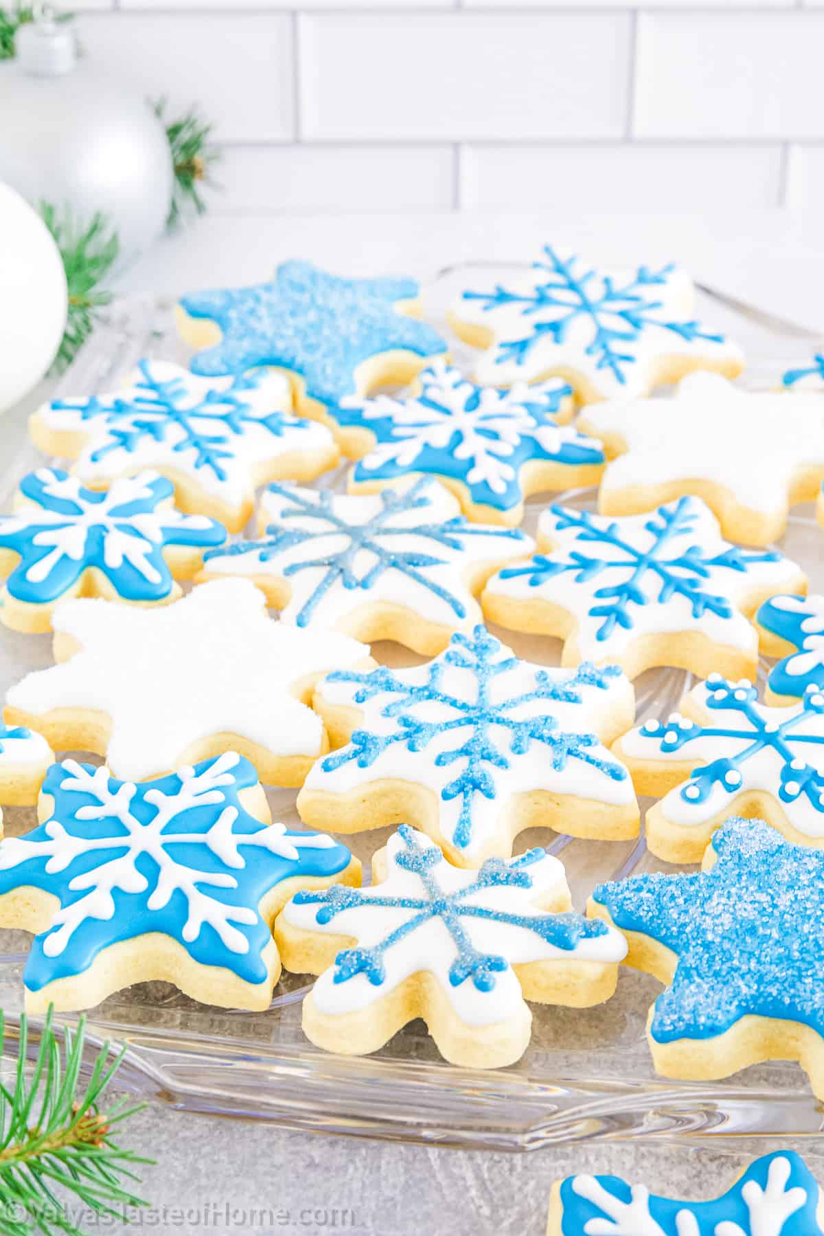 Snowflake cookies with royal icing are a delicious mix of sweet, buttery goodness, and a crisp texture, all topped with a layer of glossy royal icing.