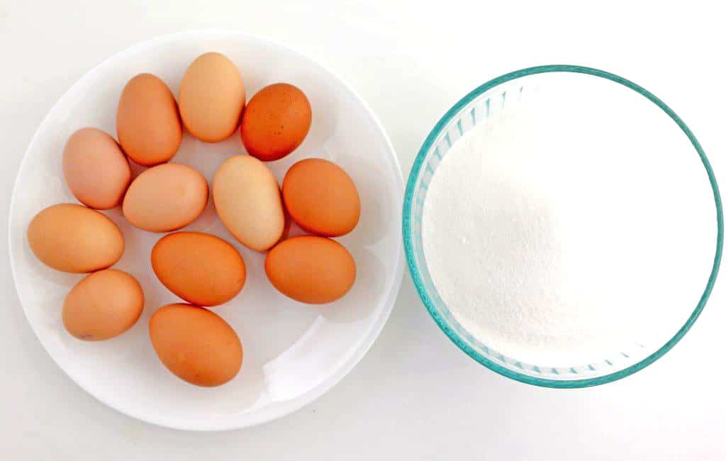 These are two main ingredients for the meringue. We need 12 large eggs at room temperature, and 4 cups of granulated sugar to make the perfect, crispy meringue.