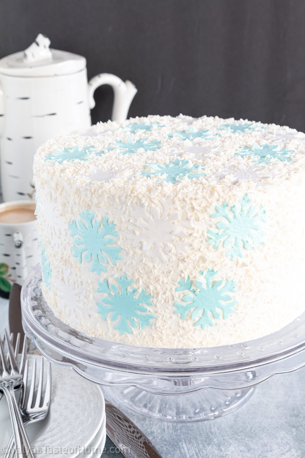 This cake recipe is a real showstopper that’s a combination of sponge cake, soaking syrup, Greek yogurt-based frosting, and beautiful snowflake toppings.